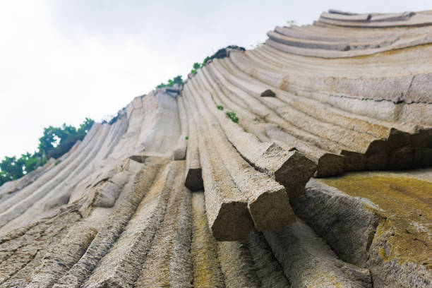 istock basalt columns forming a coastal rock at Cape Stolbchaty on Kunashir Island, close-up 1425243072