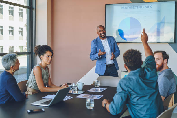 istock Business people planning in marketing meeting at work, talking strategy with data and communication with employees in seminar conference. Employee asking question in training workshop in office 1425243792