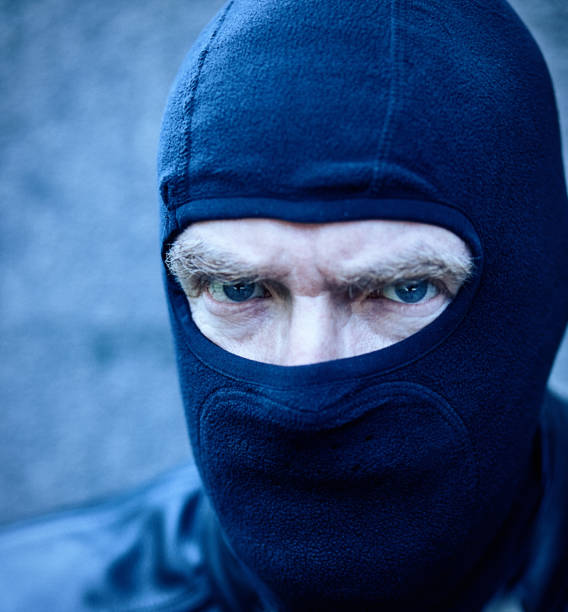istock Scary man masked by balaclava stares daggers at the camera 1425244041