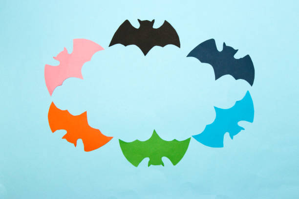 istock colorful bats on blue background form copy space, creative art halloween design, flat lay, paper craft 1425244583