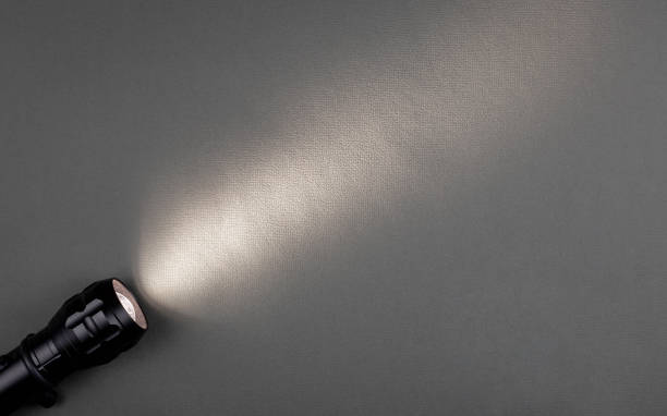 istock A bright beam of light from a flashlight shines on a gray background 1425244584