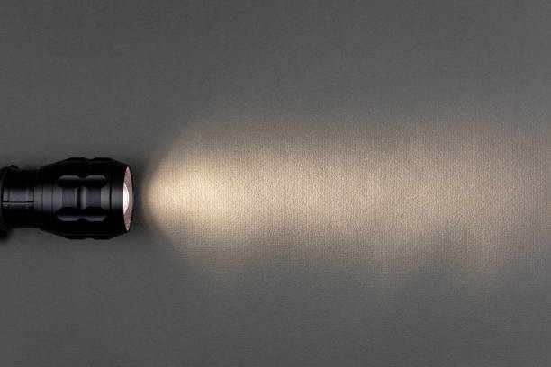 istock A bright beam of light from a flashlight shines on a gray background 1425244609