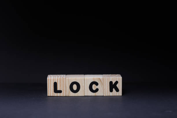 istock Lock word on wooden cubes on black background 1425246938