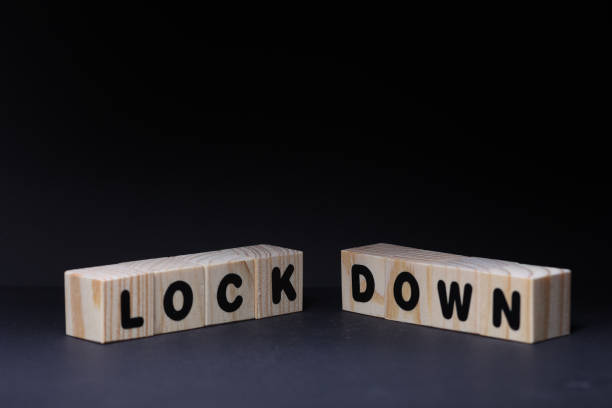 istock Lock & Down word on wooden cubes on black background 1425246994
