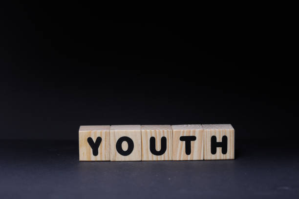 istock Youth word on wooden cubes on black background 1425247742