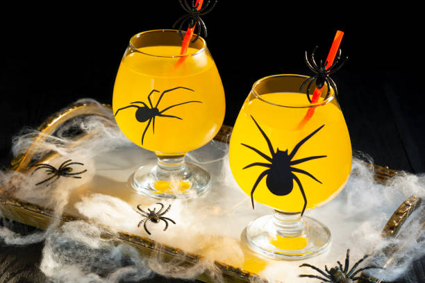 istock Halloween orange cocktail in glasses with spiders 1425248242