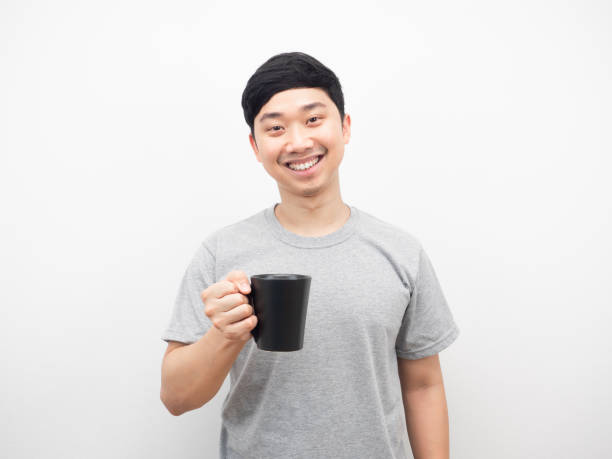 istock Asian man holding coffee cup smiling happy emotion white background 1425248846