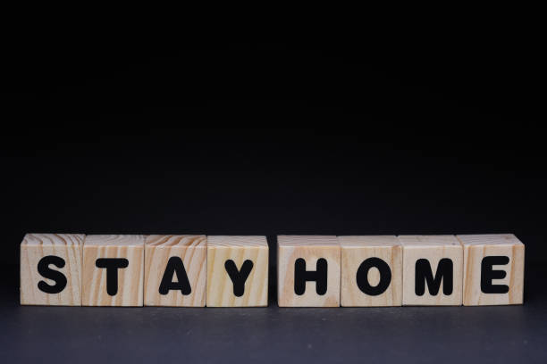 istock Stay home word on wooden cubes on black background 1425248936