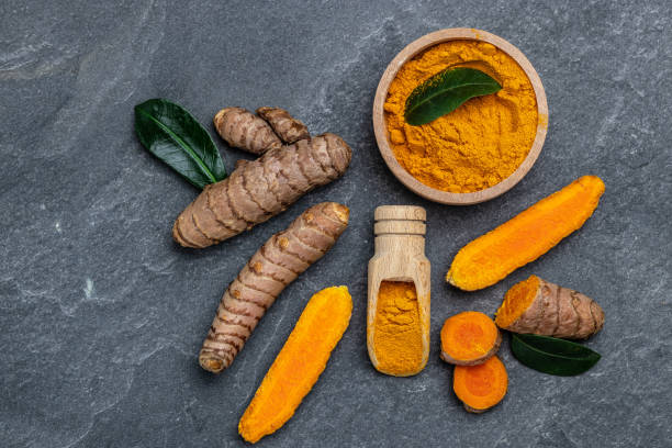 istock curcuma or curcumin root. Turmeric powder and fresh turmeric. on concrete background. Spice, natural coloring, alternative medicine. top view 1425250653