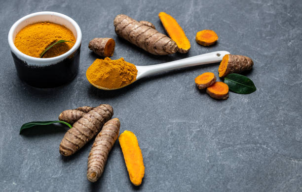istock curcuma or curcumin root. Turmeric powder and fresh turmeric. on concrete background. Spice, natural coloring, alternative medicine. top view 1425250655