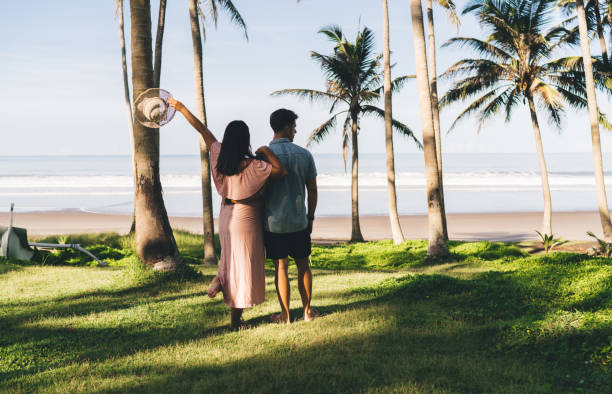 istock Faceless couple standing on tropical beach and hugging 1425250741