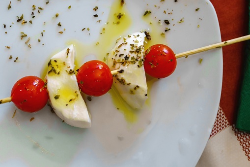 Caprese salad, Italian salad, specifically from Capri, composed of tomato slices and fresh mozzarella.