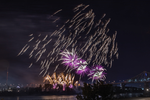 Fireworks over the St. Lawrence River in Montreal near the Jacques Cartier Bridge and in front of the Amusement Park.