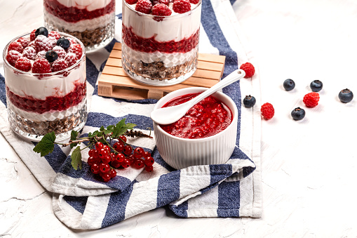 Yogurt parfafait with granola and berries. Sweet and healhty breakfast dessert, Yogurt, blueberries and raspberries.