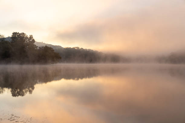 istock First light over a fog covered lake 1425255839