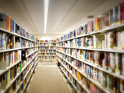 Calgary, Alberta - February 6, 2022: Interior of Calgary`s Central Branch of the Calgary Public Library. The library opened in November 2018 and was designed by renowned Snohetta firm.