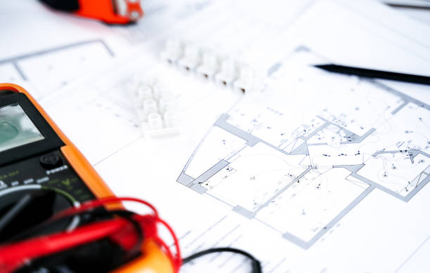 istock Making repairs,planning electricity project in house.Drawings,diagrams,plan for electrification of apartment, building. Devices and accessories, voltmeter, wires, screwdriver, pliers and tape measure 1425259425