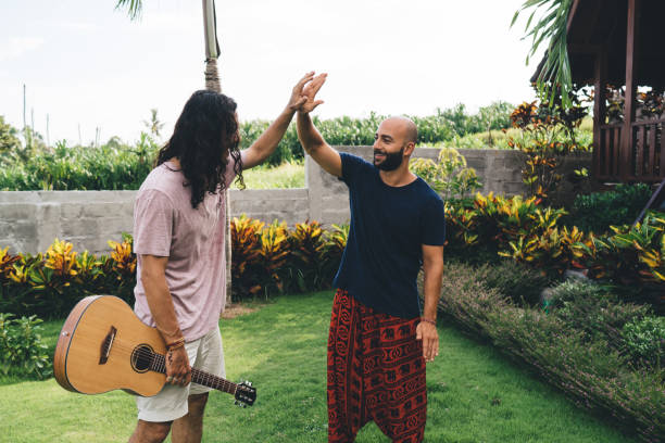 istock Smiling multiethnic friends giving high five 1425259915