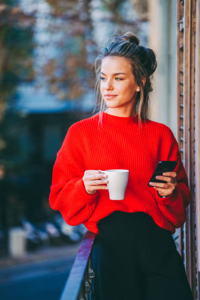 istock Woman texting and enjoying coffee in the morning 1425260049