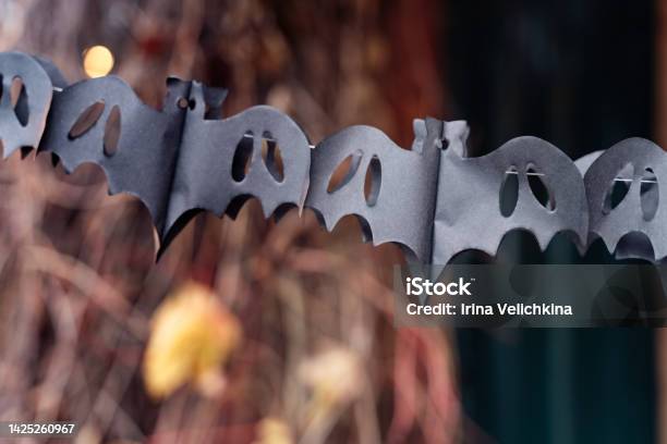 Black Paper Cut Out Garland In Shape Of Flying Batsburning Lanterndecorating Of Porch Outdoor On Street For Halloween Holidaydiy Homestreet Decorationentertainment For Childrenhorror Atmosphere Stock Photo - Download Image Now