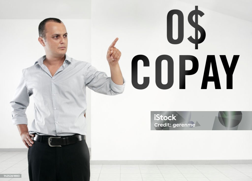 0$ COPAY Man touching ‘0$ COPAY’ text on transparent board Adult Stock Photo