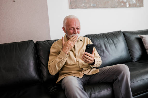 istock Senior man having video call at home 1425268772