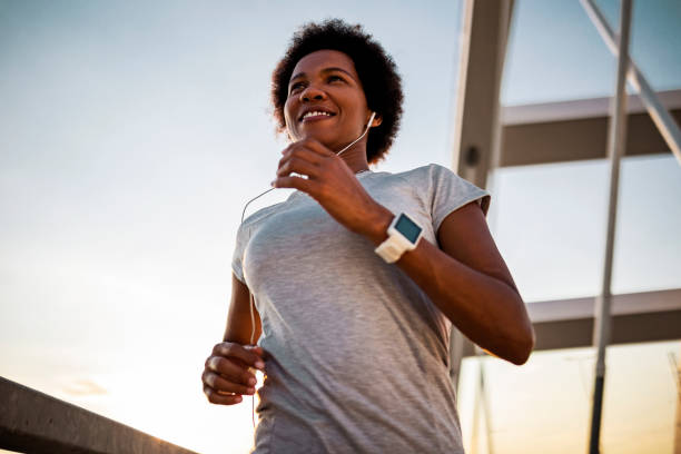 istock African woman running on the bridge smiling 1425269812