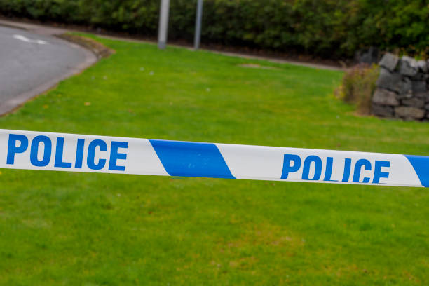 istock Police Tape at Roadside 1425271973