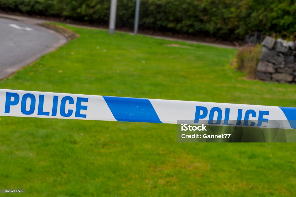 Police Tape at Roadside Police marker tape for cordoning crime scene Accidents and Disasters Stock Photo