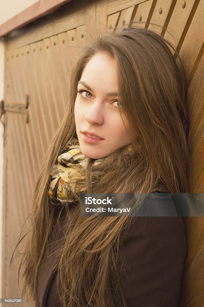 Portrait of young woman Portrait of young brunette woman with long straight hair, wearing coat and scarf. Outdoors shooting 18-19 Years Stock Photo