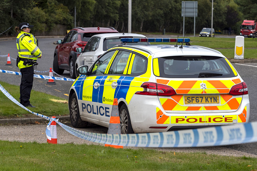 Dyce, Scotland, UK - September 19, 2022: Police and police car guarding a crime scene after an incident in Dyce, Scotland.