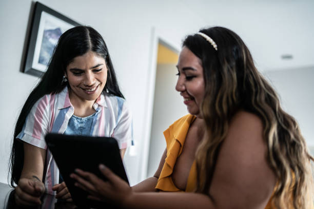 istock Female friends using digital tablet at home 1425276469