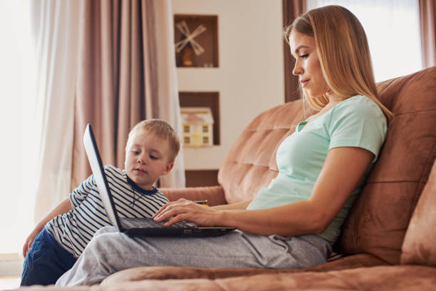 istock Young mother with child studying on laptop 1425278168
