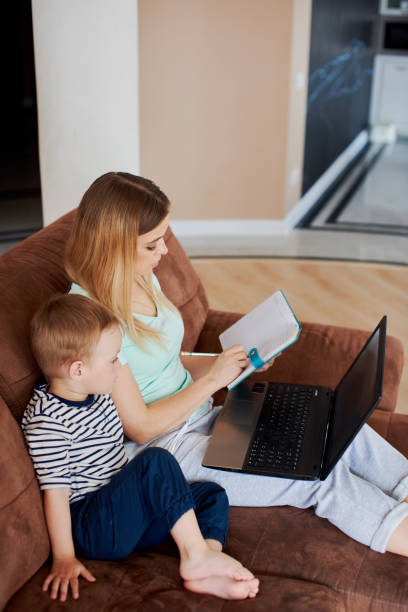 istock Mom and son on online class together 1425278171