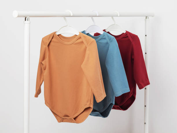 istock Multicolored long sleeve baby bodysuits hanging on a hanger 1425280914