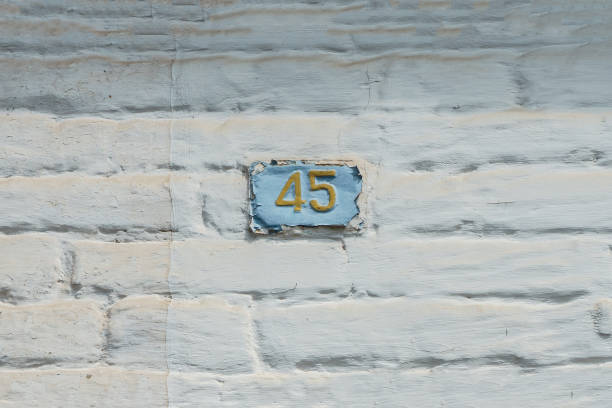 istock House Na 45 sign on white brick wall , forty-five 1425280967