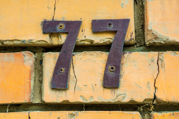 istock house number 77 made of iron on a brick wall 1425281073