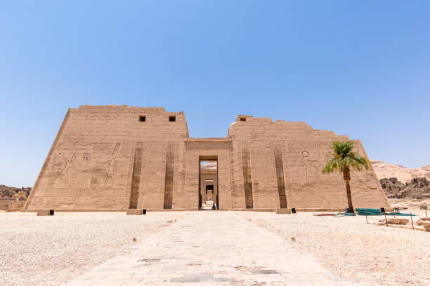 The Temple of Ramesses III, Luxor, Egypt The Temple of Ramesses III, Luxor, Egypt - July 26, 2022:  The Temple of Ramesses III at Medinet Habu was an important New Kingdom period temple structure in the West Bank of Luxor in Egypt. Aside from its size and architectural and artistic importance, the mortuary temple is probably best known as the source of inscribed reliefs depicting the advent and defeat of the Sea Peoples during the reign of Ramesses III. medinet habu stock pictures, royalty-free photos & images