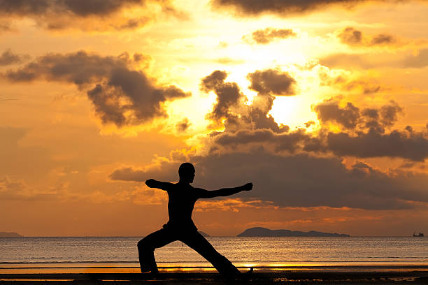 istock Man silhouette doing yoga exercise archer 142528142