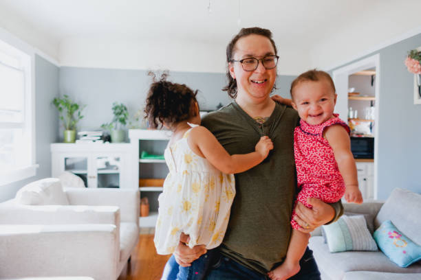 istock Father and Daughters Happily Playing Together At Home 1425281494