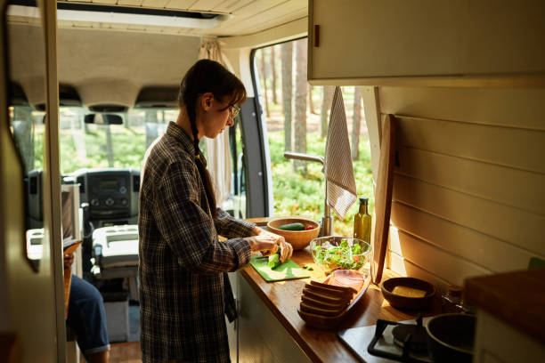 istock Woman preparing salad in motorhome 1425281848