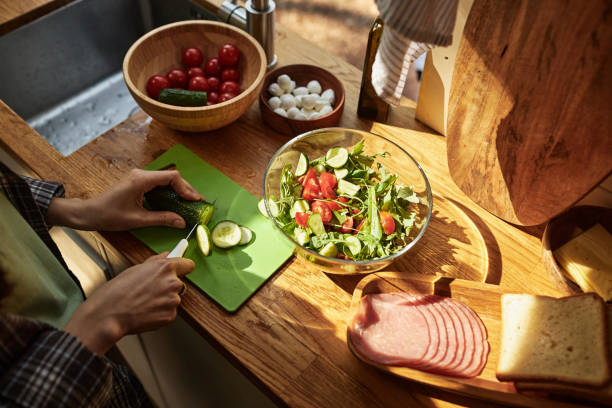 istock Girl cutting fresh vegetable for salad 1425281861