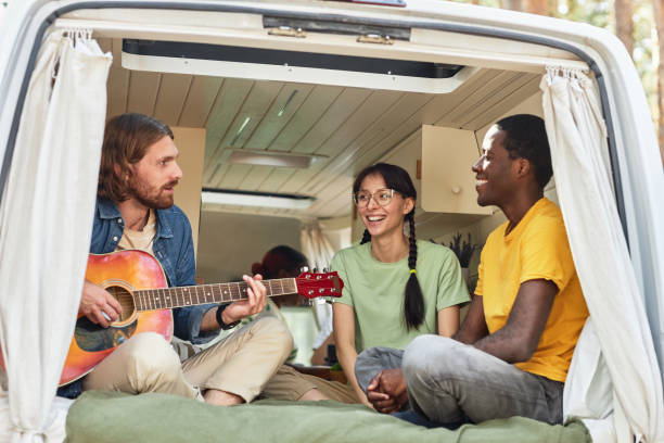istock Young people playing guitar in motorhome 1425281892