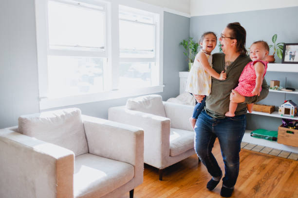 istock Father and Daughters Happily Playing Together At Home 1425282875