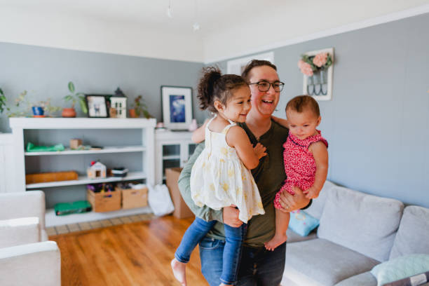 istock Father and Daughters Happily Playing Together At Home 1425282876