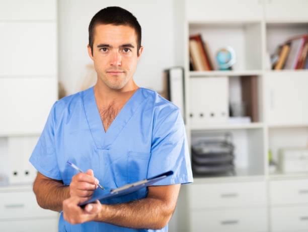 istock Positive latino doctor with folder of documents at office 1425283004