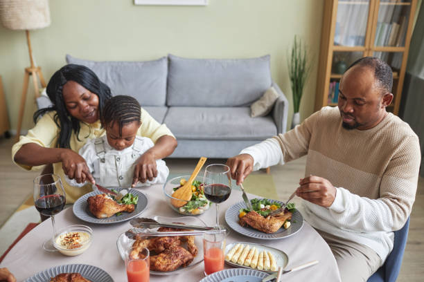 istock Woman feeding her child during dinner 1425283742