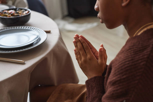 istock Little girl praying before dinner 1425283744