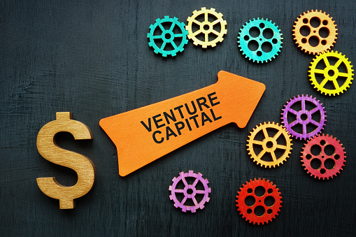 Venture capital concept. Dollar sign, an arrow and gears.