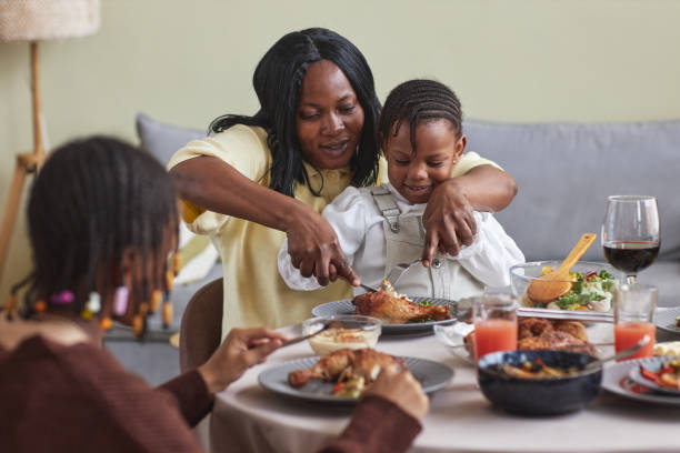 istock Mom feeding her child with dinner 1425283793